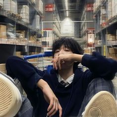 a man sitting on the floor in a store with his headphones up to his ears