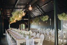 the tables are set with white linens and centerpieces