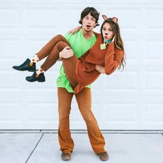 a man and woman dressed up as scooby and the girl is carrying her