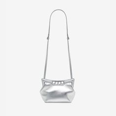 Inspired by the sharp and structured shoulders of the tailoring silhouettes, this mini Peak bag is handcrafted from metallic silver lambskin leather with a curve-shaped magnetic frame, juxtaposed with a soft body. The bag can be worn either over the shoulder or across the body using the adjustable leather strap. Evening Shoulder Bag With Palladium Hardware In Metallic Silver, Metallic Silver Shoulder Bag With Palladium Hardware For Evening, Modern Metallic Silver Shoulder Bag For Evening, Modern Silver Evening Shoulder Bag, Metallic Silver Leather Evening Bag, Magnetic Frame, Magnetic Frames, Stefano Gabbana, Central Saint Martins