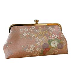 A simple and elegant clutch made using silk fabric, once part of a Japanese kimono. Lovely flower blossoms can be found on both sides of the clutch. The base colour of the fabric is pink. You will receive the clutch as shown in the first three photos.  There's ample space to store your essentials for an evening out - cards, cash, keys, lipstick and phone.  The body of the purse is padded and attached to a light gold coloured metal frame.  The interior is lined with good quality cotton fabric. Pink Rectangular Clutch For Spring, Pink Rectangular Spring Clutch, Spring Pink Rectangular Clutch, Spring Rectangular Pink Clutch, Elegant Pink Pouch Coin Purse, Elegant Pink Clutch Coin Purse, Elegant Pink Coin Purse For Formal Occasions, Elegant Pink Coin Purse For Gifts, Elegant Pink Clutch For Spring