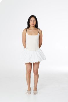 Mid-rise mini skirt with hidden bloomers and bubble hem. Crisp poplin fabric compliments any summer fit. Fit Details ✿ ✦ Fitted✦ Cotton✦ Hand wash cold, lay flat dry ✦ Model is 5'8" and wears a size S Measurements ⋱ (inches) XS S M L XL Length 12 12.5 13 14 14.5 Waist 25 27 29 31.5 34.5 See our sizing guide here ⟶ Ethical Cred ꩜ Made ethically at a women-owned and operated factory in China. Produced in a small production run, under 100 units. Designed and developed by women in NYC. Delivery & Returns 🖃 USA• Free domestic shipping details here 🔗• $40 express✓ Allow 1—2 weeksInternational • Pricing by country ⟶ ✓ Allow 2—3 weeks Returns and all FAQs here 🔗 Bubble Hem, Fit Details, Moving Sale, Poplin Fabric, Second Skin, 12 12, 3 Weeks, Lay Flat, Best Sellers