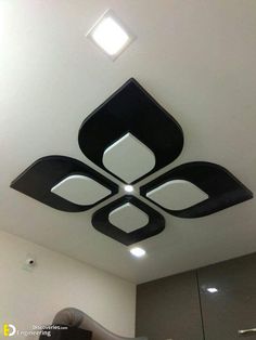 the ceiling is decorated with modern black and white designs, including square shaped lights on each side