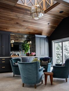 an instagramted photo of a kitchen and dining room with blue chairs in it