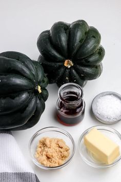 the ingredients to make this dish include butter, sugar, and pumpkins on a white surface