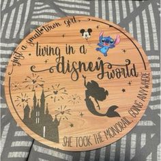 a wooden sign that says living in a disney world