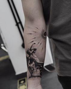 a man with a tattoo on his arm holding an umbrella and sunburst in the background