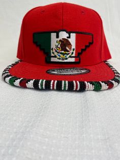 You are viewing a hand-beaded baseball hat with a Mexican Flag Huelga Bird patch. The hat is ADULT size. All beads are sewn by hand.  All patches are applied by hand. No two hats are exactly alike and will never be replicated exactly. Made by an indigenous artist, I am an enrolled member of the Jumano Nation of West Texas. Free shipping to US locations only Beaded Baseball Caps, Bead Hat, Mexican Flag, Mexican Flags, Beaded Hat, Beaded Earrings Patterns, West Texas, Bird Seed, Bead Work Jewelry