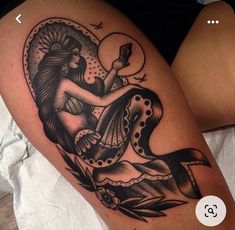 a woman's thigh with a tattoo design on it