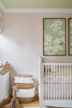 a baby's room with pink and green wallpaper