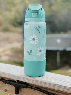 a water bottle sitting on top of a wooden bench