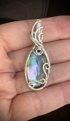 This beautiful Himalayan rainbow mother of pearl pendant.  Pendant measured  about 1 3/4" tall and 3/4" wide, it comes with a complimentary 18" stainless steel chain and in a gift box, ready for gifting!  All of my pieces are made with high quality wire from Riogrande. These are not costume pieces that will chip away or rust over time. They will last forever if taken care of, which is why I include a free polishing cloth with every order. Quality is very important to me! If you have any question Silver Mother Of Pearl Jewelry For Mother's Day, Mother Of Pearl Silver Jewelry For Mother's Day, Mother's Day Silver Mother Of Pearl Jewelry, Mother Of Pearl Pendant Jewelry As Gift, Mother Of Pearl Jewelry With Large Pendant As Gift, Mother Of Pearl Large Pendant Jewelry Gift, Iridescent Pendant Jewelry As A Gift, Elegant Iridescent Wire Wrapped Jewelry, Iridescent Pearl Pendant Jewelry Gift