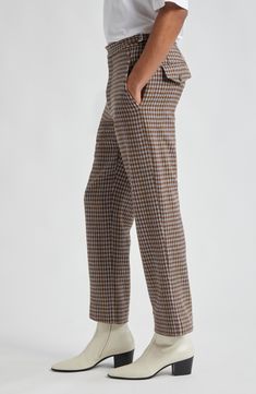 Inspired by 1950s men's suiting, these trousers reproduced the vintage silhouette in merino wool herringbone patterned in brown-and-black checks. 28" inseam; 17" leg opening; 11 1/2" front rise; 17 1/2" back rise (size 32) Zip fly with button-tab closure Front slant pockets; back button-flap pockets Adjustable buckle waist tabs 100% merino wool Dry clean Made in France Designer Clothing Brown Wool Straight Pants, Brown Wool Dress Pants For Work, Plaid Tweed Bottoms For Fall, Plaid Bottoms For Business In Fall, Tailored Brown Wool Dress Pants, Brown Wool Tapered Leg Dress Pants, Brown Wool Dress Pants With Tapered Leg, Fitted Brown Wool Dress Pants, Brown Dress Pants With Straight Hem For Business