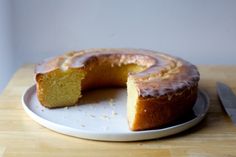 a white plate topped with a cake covered in frosting