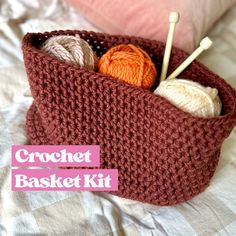 a crochet basket with yarn and knitting needles