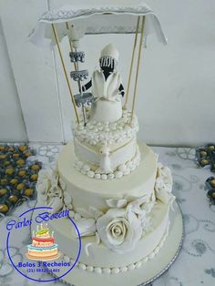 a wedding cake with two bride and groom figurines on top