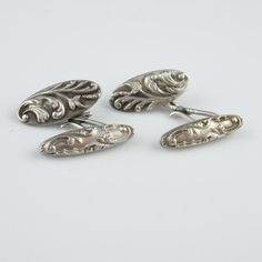 An elegant pair of original antique circa 1910 belle epoque sterling silver handmade repousse design double sided cufflinks.These fantastic cufflinks are an original belle epoque pair and not a reproduction. They are in excellent condition ready to wear. I adore the floriate but masculine design which is so timeless and is still so fashionable today. Today it would take several days work to work the fine silver entirely by hand using the repousse technique and hand engraving to make this amazing Luxury Vintage Formal Cufflinks, Luxury Antique Cufflinks As Gift, Victorian Engraved Earrings For Formal Occasions, Luxury Silver Hallmarked Cufflinks, Vintage Polished Wedding Earrings, Vintage Wedding Earrings With Polished Finish, Classic Hallmarked White Gold Cufflinks, Formal Oval Engraved Earrings, Formal Sterling Silver Jewelry With Screw Back