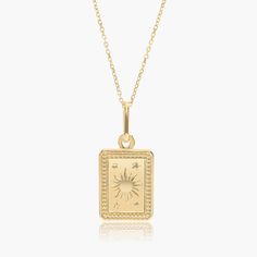 a gold necklace with a sun and stars on it