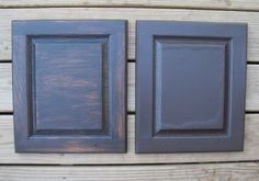 two dark brown kitchen cabinet doors on a wooden wall