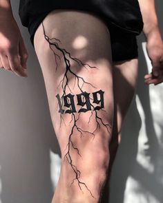 a man's leg with a tattoo that reads, booy on it and lightning bolt