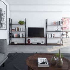 a living room filled with furniture and a flat screen tv on top of a wooden table