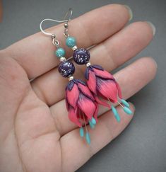 Long, but lightweight floral dangle earrings are made of polymer clay in vivid fuchsia pink, purple and teal colors. These beautiful flowers are so romantic and full of joy, they make me smile just looking on them. The earrings will be a great jewelry gift for every woman.The ear hooks are made of stainless steel (hypoallergenic, lead and nickel free).Dimensions: 2 1/2 inches from top of ear wire, width 1/2 inchesCan be made in different sizes and colors - please feel free to ask me about the cu Pink Polymer Clay Jewelry With Ear Wire, Handmade Pink Polymer Clay Flower Earrings, Pink Flower Shaped Polymer Clay Earrings, Pink Flower-shaped Polymer Clay Earrings, Pink Handmade Flower Polymer Clay Earrings, Handmade Pink Flower Earrings In Polymer Clay, Pink Polymer Clay Flower Earrings, Fantasy Pendant, Flower Dangle Earrings