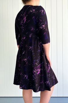 Purple Marble Skater Dress features neon purple streaks from a marble pattern on a black background. Designed with 3/4 length fitted sleeves, invisible pockets, and a v neck-line, in a knee length a-line style. NEW SIZING Range: Skater DressStyle: 3/4 Sleeve - V-neck - Knee Length Dress Size Recommendation: If in between sizes, size down for a firmer fit, size up for a looser fit. Made with curves in mind Sizes 6-28 Two side pockets V-neckline 3/4 length fitted sleeves Knee length design Crease proof - no ironing needed! Skater/A-line style Suitable for curvy body types Relaxed fit vintage style All over print Made for comfort A special soft to touch brushed fabric (cottony soft) Polyester/spandex blend (like the casual leggings) Stretches 3-4 sizes with ease Model 1 wears: size S/M - Stat Patterned Dresses, Purple Streaks, Curvy Body Types, Dresses For Spring, Casual Leggings, Dresses Australia, Purple Marble, Fitted Sleeves, Fleece Leggings