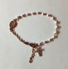 Italian Designer Silver Rosary Bracelet With 3mm Round White Beads Beads. 925 Sterling Silver With Rose Gold Plating. Very versitile and classic with a modern flair, this bracelet is sure to compliment any outfit. Its perfect for layering with other pieces in your collection. Fits wrists from 7-8 inches. Silver Rosary, Rosary Bracelet, Italian Designer, Rosary Beads, Design Silver, White Beads, Italian Design, Rosary, Gold Plating