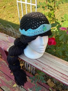 Crochet yarn wig with 20 inch long ponytail Teal tiara with crystal stone Pony tail is embellished with gold thread | Jasmine Yarn Wig Yarn Wig, Long Ponytail, Handmade Costumes, Crochet Cap, Gold Thread, Costume Hats, Black Crochet, Gold Threads, Crystal Stone