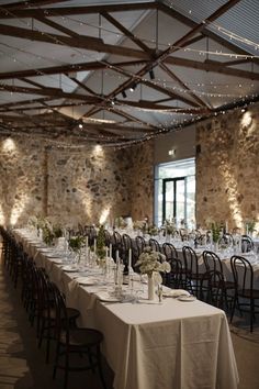 the tables are set with white tablecloths and centerpieces for an elegant event