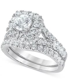 a wedding ring set with an oval cut diamond surrounded by smaller round diamonds on each band