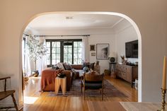 a living room filled with furniture and wooden floors