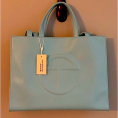 Telfar Medium Pool Blue Shopping Bag Sold Out Never Used Modern Blue Bag For On-the-go, Modern Light Blue Bags With Detachable Handle, Modern Light Blue Top Handle Shoulder Bag, Designer Light Blue Top Handle Shoulder Bag, Light Blue Double Handle Bag With Top Carry Handle, Modern Light Blue Bag With Removable Pouch, Light Blue Shoulder Bag With Double Top Carry Handles, Trendy Blue Shopping Bag, Trendy Blue Shopping Bags