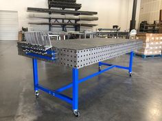 a large metal table sitting inside of a warehouse