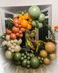 an assortment of balloons are arranged in the shape of a dinosaur