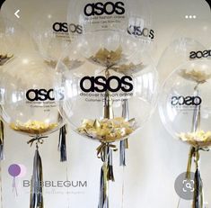 several clear balloons with ribbons hanging from them