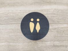 a black and gold sign with two people on it