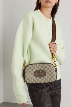 Brown Neo Vintage GG Supreme textured leather-trimmed coated-canvas shoulder bag | GUCCI | NET-A-PORTER Gucci Coated Canvas Shoulder Bag With Branded Hardware, Gucci Shoulder Bag With Branded Hardware In Coated Canvas, Gucci Monogram Canvas Shoulder Bag With Leather Trim, Gucci Shoulder Bag With Leather Trim And Monogram Canvas, Gucci Bag With Gold-tone Hardware In Signature Coated Canvas, Gucci Beige Signature Coated Canvas Bag, Beige Gucci Bags In Coated Canvas, Gucci Leather Shoulder Bag With Leather Trim, Gucci Luxury Shoulder Bag With Leather Trim