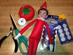 an elf is sitting on the floor next to scissors and other items