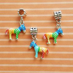 Painstakingly enameled in a rainbow of colors, this fully 3 dimensional horse charm comes with a bail already attached for bracelet making. Just string some beads, add the horse charm and Yay! Bracelet done! (If you only want the charm, just open and remove the jump ring). Really adorable! Listing is for 3 charms. Novelty Multicolor Charm Bracelet, Multicolor Charms With Lobster Clasp For Gifts, Multicolor Metal Charms For Gifts, Multicolor Enamel Charms For Gifts, 3d Bracelet, Rainbow Horse, Fimo Beads, Unicorn Jewelry, Unicorn Charm