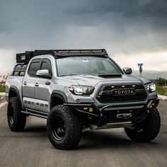 a gray toyota truck parked on top of a parking lot