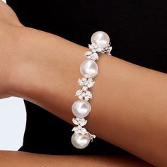 Sku: N2757 Handmade Item Metal: 925 Sterling Silver Metal Color: Sliver Finish: Polished Gemstone: Lab Created Sapphire Stone Cut: Round Cut Stone Color: Pearl & White Length: 6'' Inches Width: 12.8mm Total Carat Weight Approximately 11.01 Carat Center Pearl Size: 12mm Bracelet Clasp Type: Box Nickel Free: Yes White Diamond Pearl Bracelet For Anniversary, Fine Jewelry Pearl Bracelets For Wedding, White Pearl Diamond Bracelet For Anniversary, Elegant White Gold Pearl Bracelet With Diamonds, Fine Pearl Bracelets For Wedding, Pearl White Gemstone Jewelry, White Pearl Bracelet For Formal Occasions, White Pearl Bracelet For Formal Events, Classic Silver Bracelet With Jewels