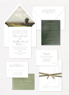 the wedding stationery is set up on top of each other