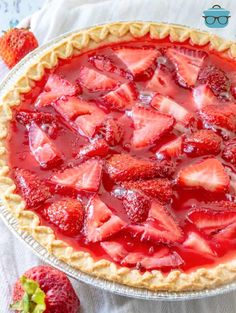 a pie with sliced strawberries on top