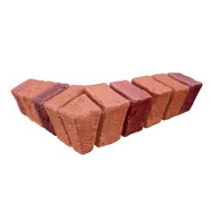 a row of red bricks sitting next to each other on top of a white surface