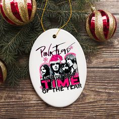 an ornament hanging from a christmas tree with pink floyd and the band on it