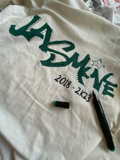 a t - shirt with the name jazkie written on it and some crayons next to it