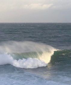 a person riding a wave on top of a surfboard