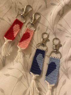 three crocheted key chains with hearts on them