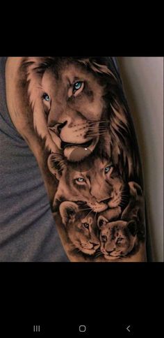 a man's arm with some tattoos on it and an image of two lions